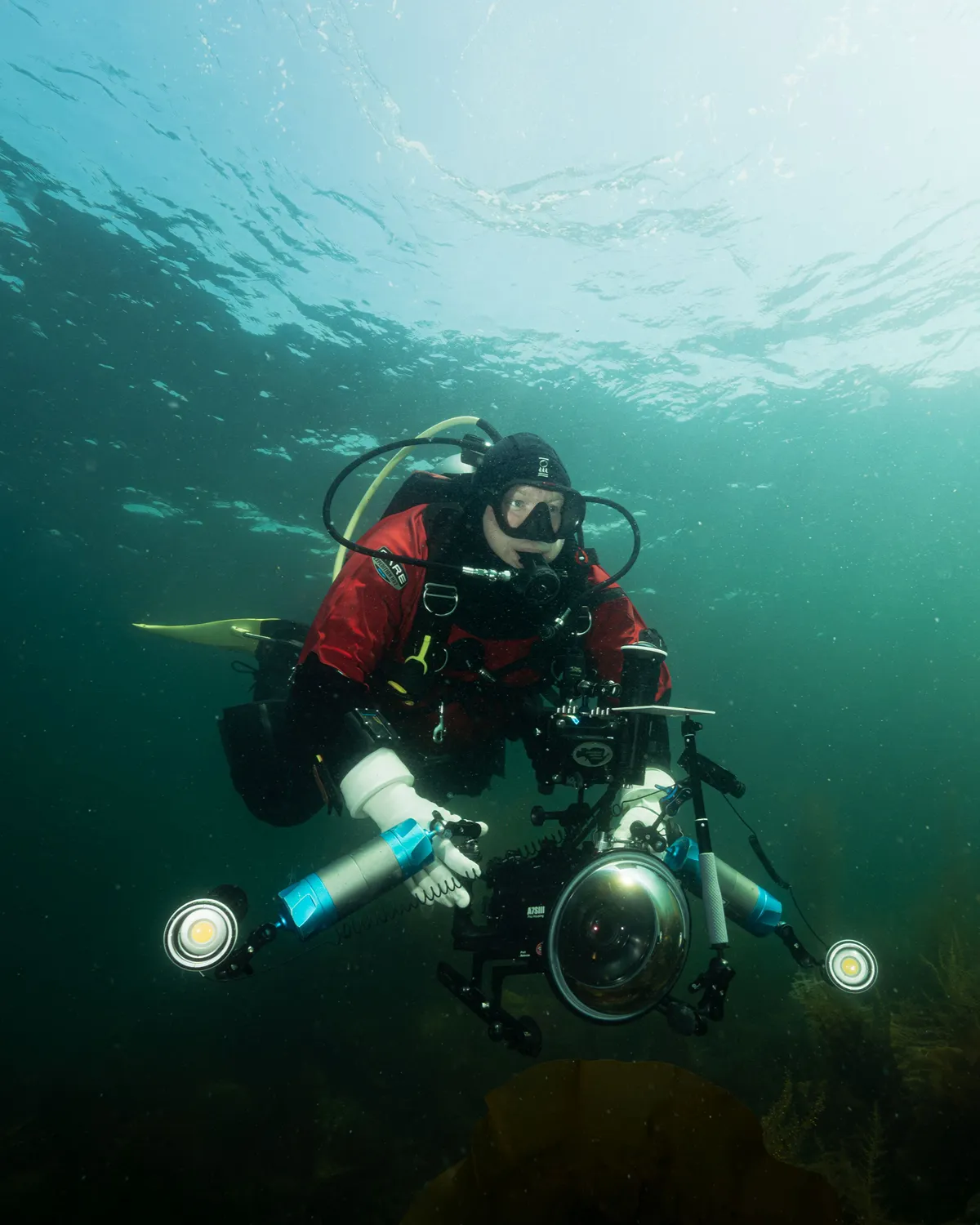 Carl Sorensen filming underwater with his professional camera system while scuba diving in British Columbia
